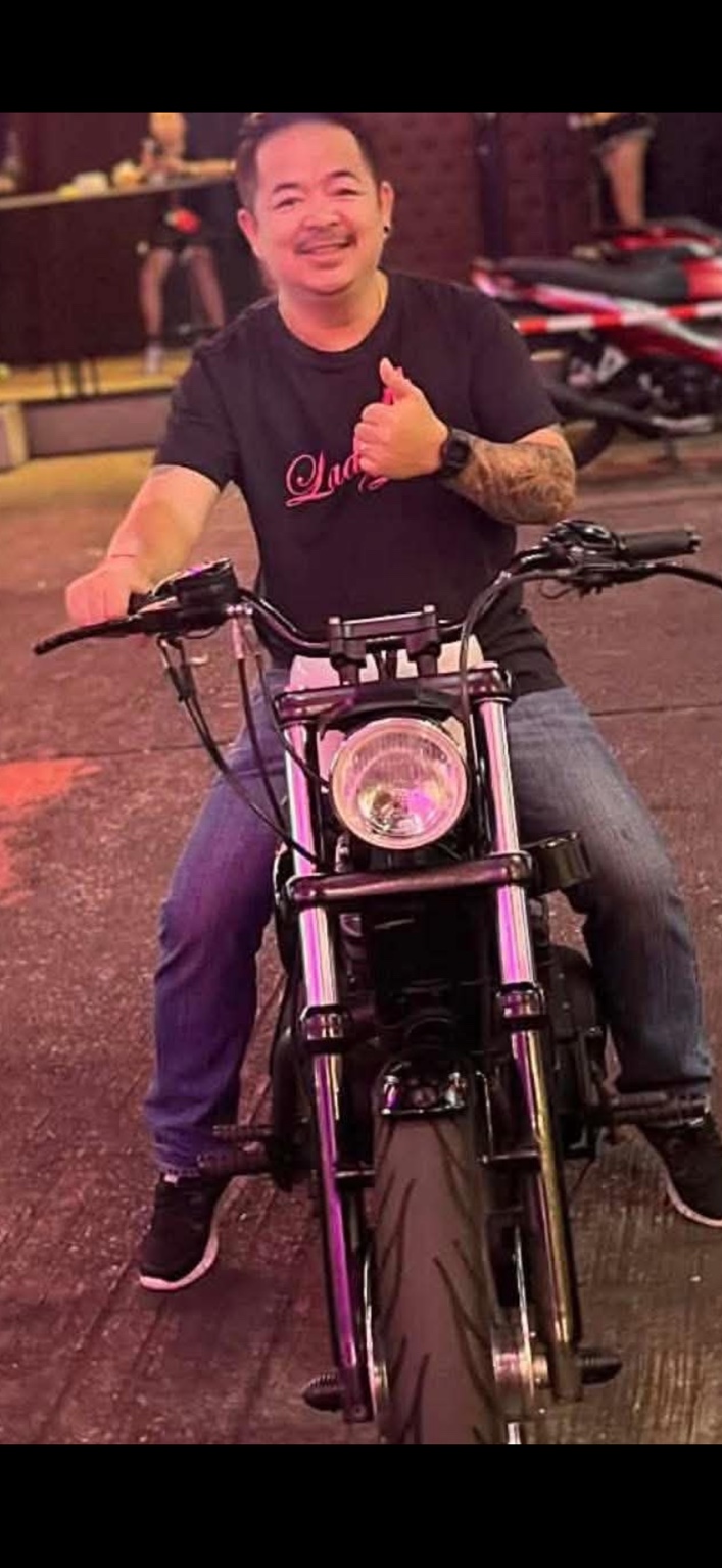 Kay smiling on a motorcycle in Pattaya.