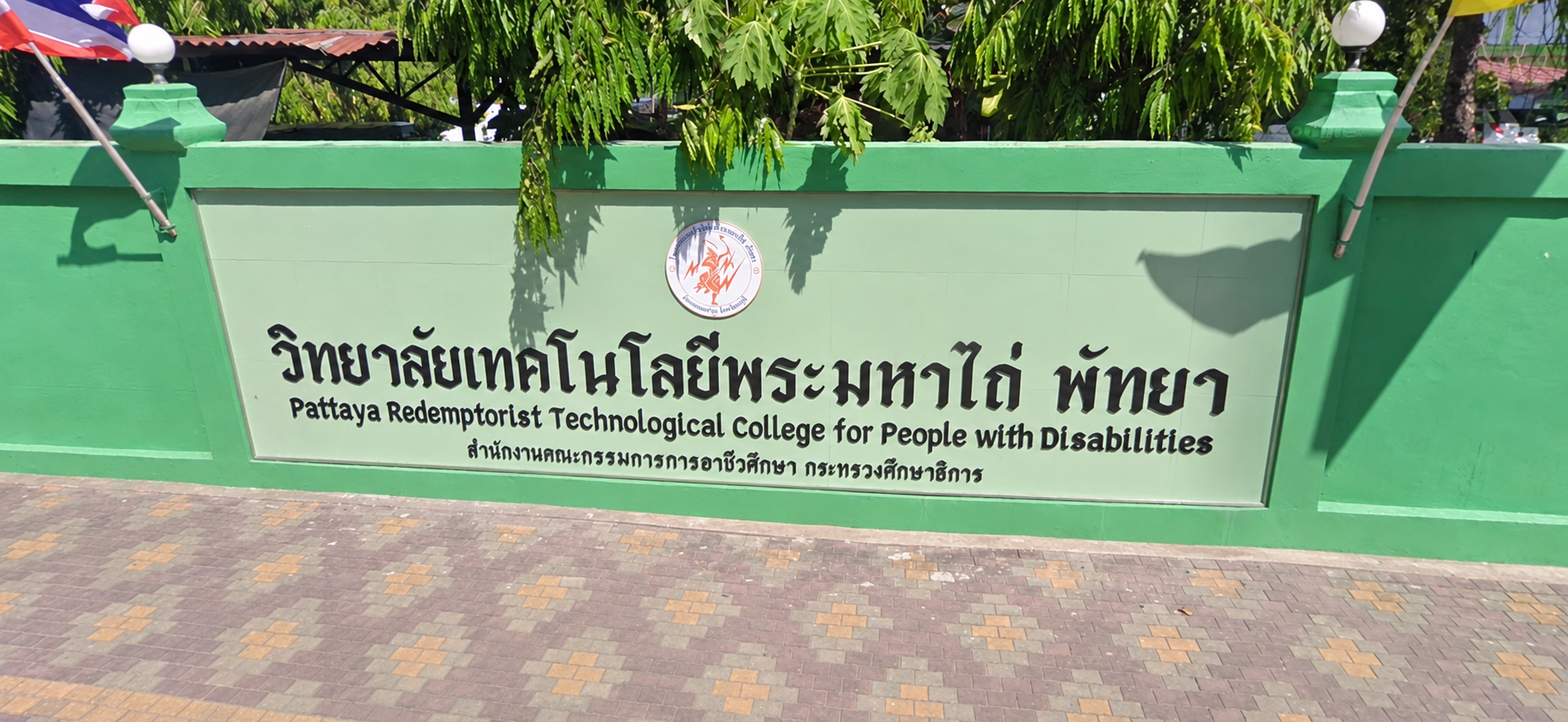 The bilingual entrance sign for Pattaya Redemptorist Technological College for People with Disabilities